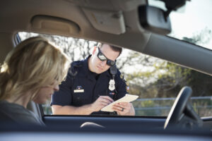 police officer writing a speeding ticket.